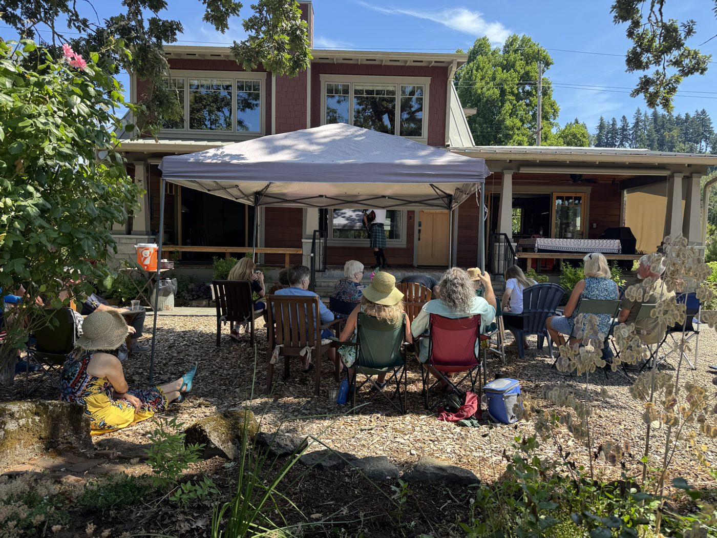 Neighbors in lawn chairs watching a porch concert