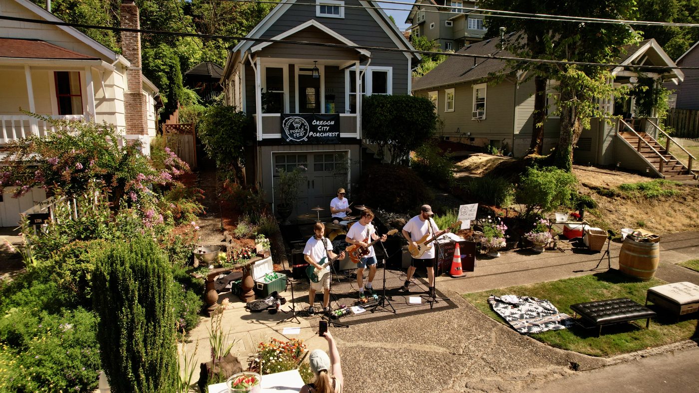 Aerial view of a Porchfest performance on a neighborhood street